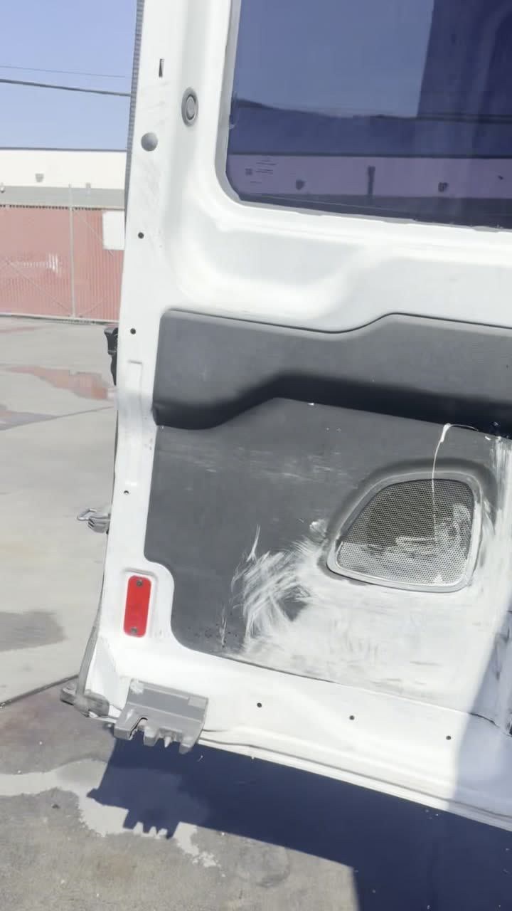 Gas powered air compressor strapped in the van with truck tires stacked behind it